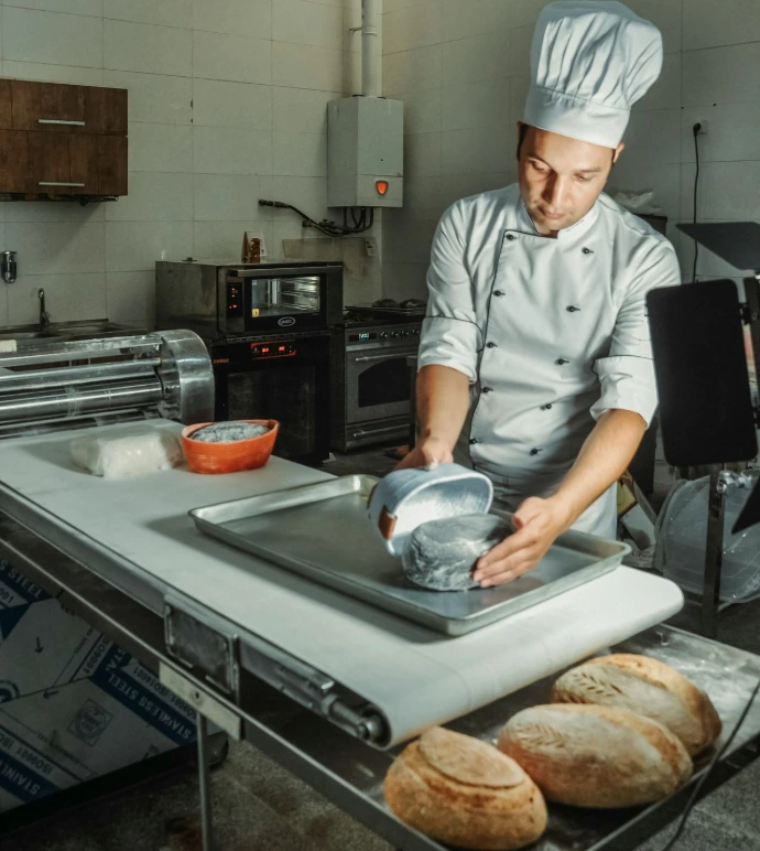 a chef making bread in a kitchen